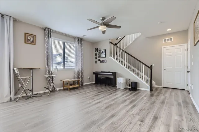 a view of a livingroom with hardwood floor and a ceiling fan