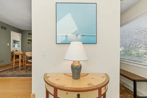a living room with a large window and a table