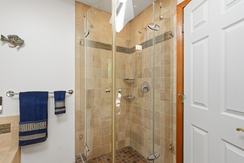 641 Salem End Road Framingham, MA 01702 - Photo 20 of 42 a bathroom with a shower and a glass door