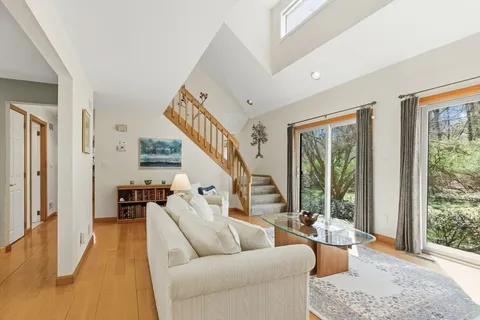 a living room with furniture and a lamp