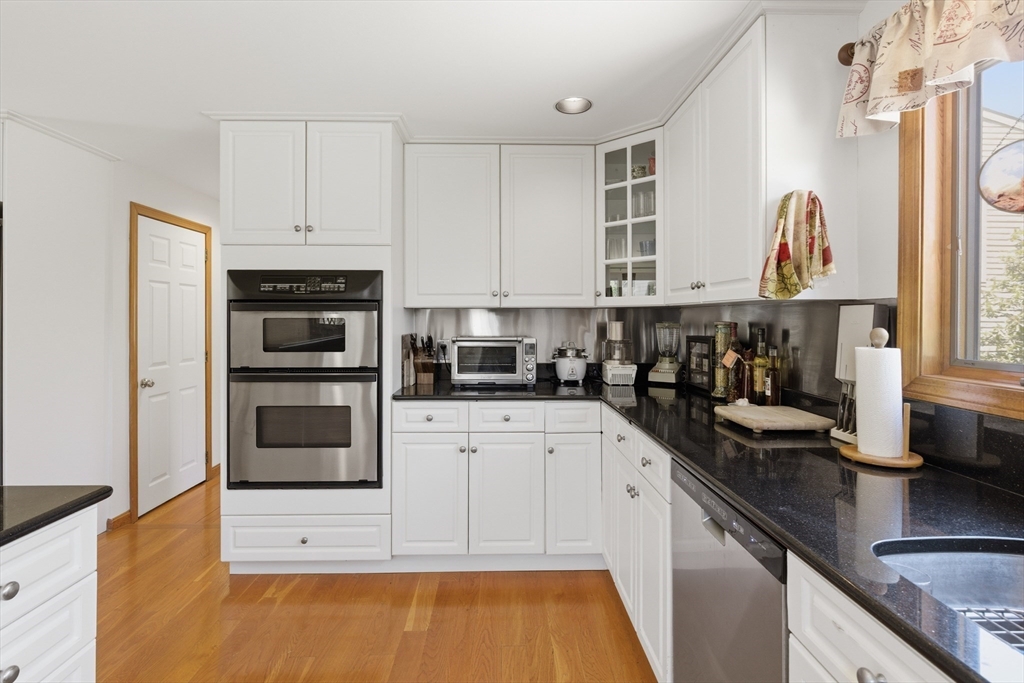 641 Salem End Road Framingham, MA 01702 - Photo 28 of 42 a kitchen with stainless steel appliances a stove a sink and white cabinets