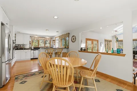 a view of a dining room with furniture window and wooden floor
