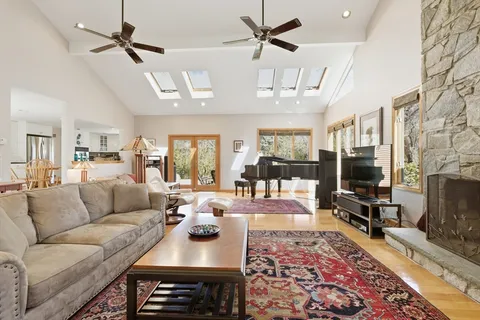 a living room with furniture a ceiling fan and a rug