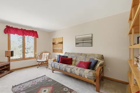 a bedroom with furniture and a window