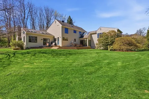 a view of a house with a yard and sitting area