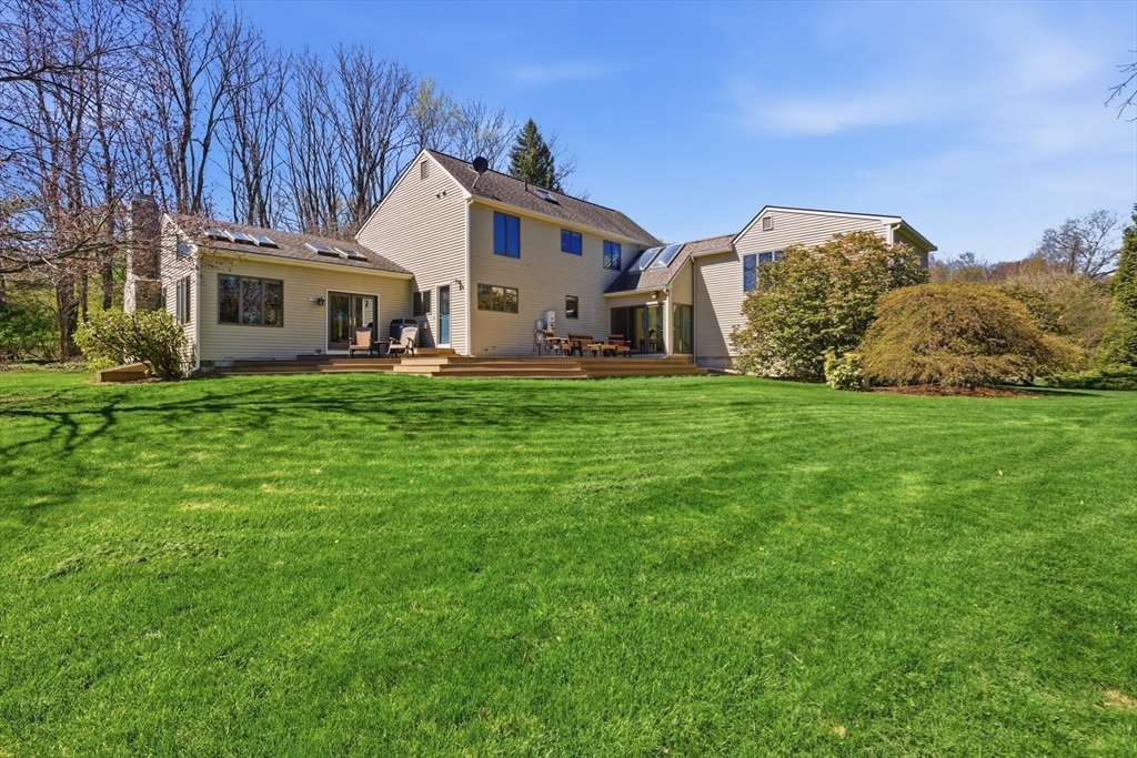 641 Salem End Road Framingham, MA 01702 - Photo 6 of 42 a front view of a house with a garden