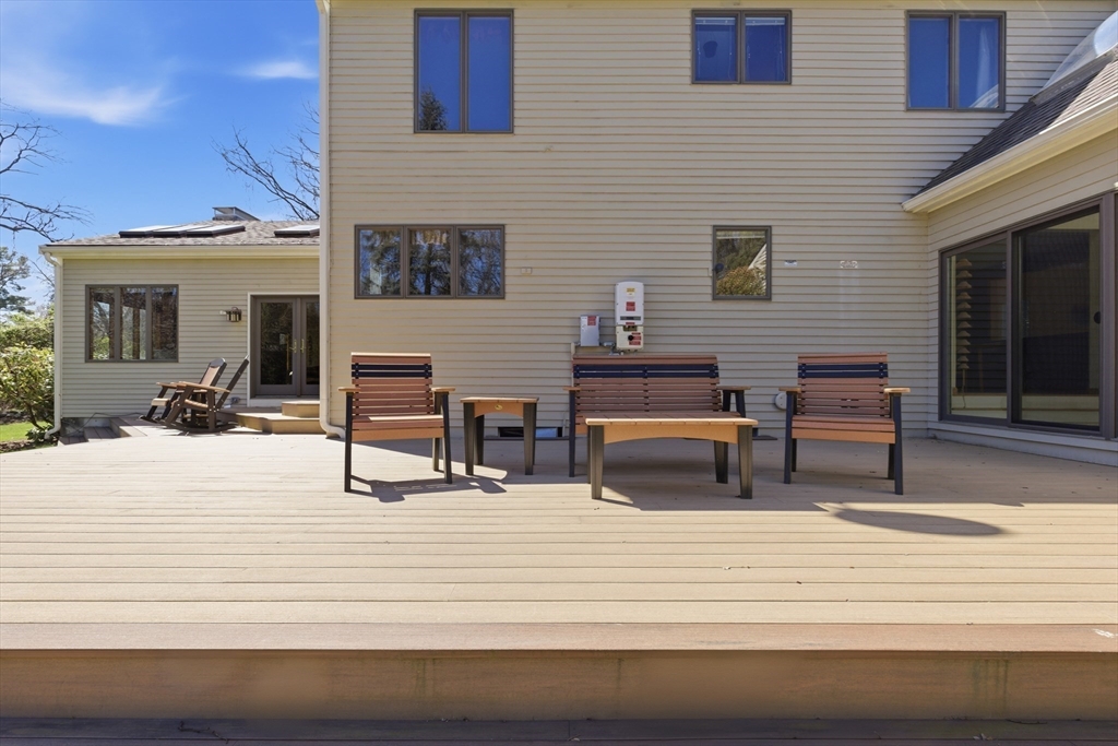 641 Salem End Road Framingham, MA 01702 - Photo 8 of 42 a view of a terrace with furniture and wooden floor