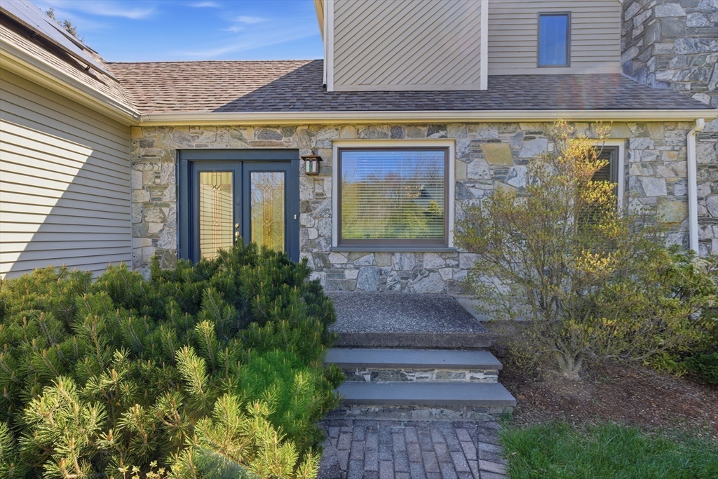 641 Salem End Road Framingham, MA 01702 - Photo 9 of 42 a front view of a house with garden