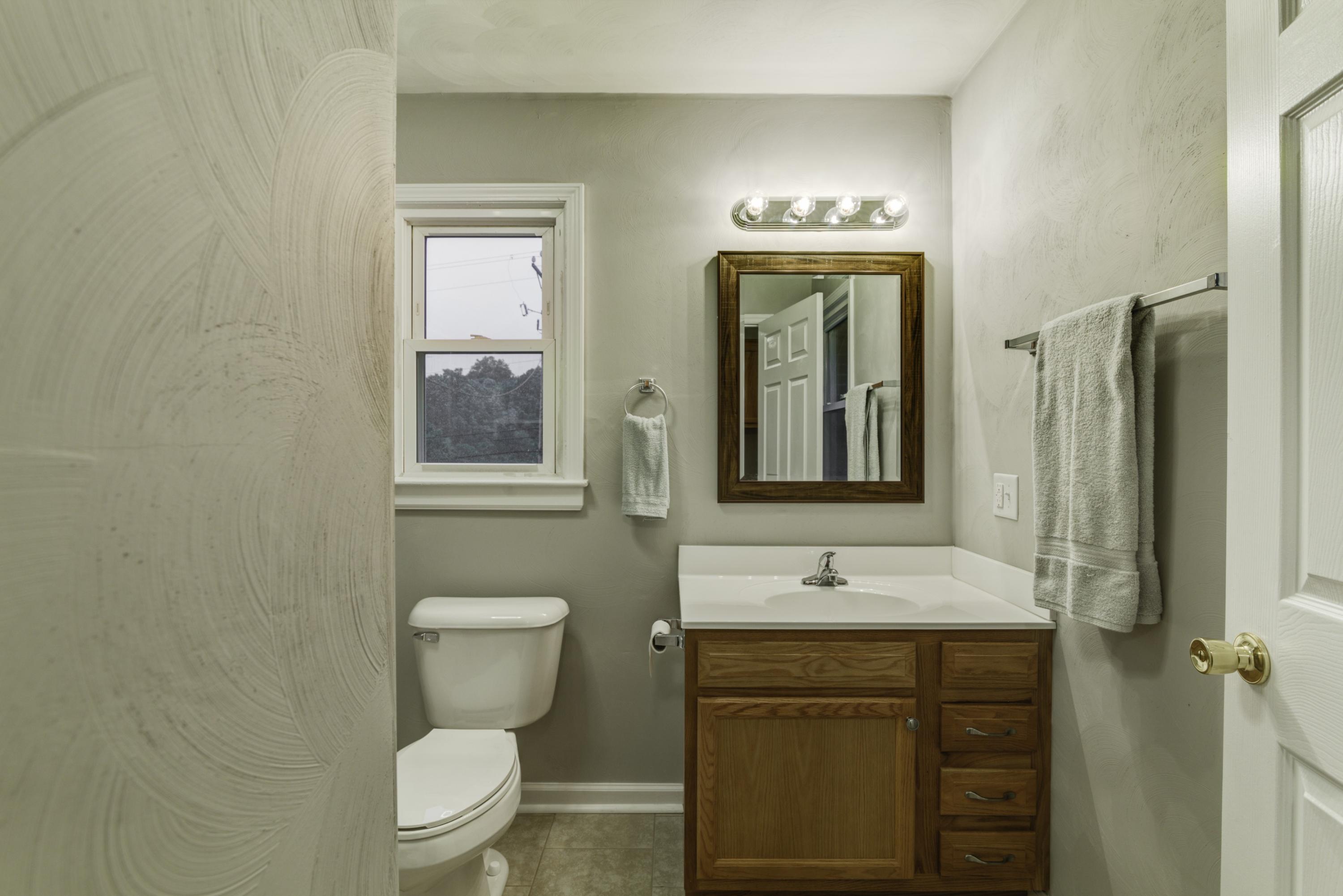 4600 Blue Ridge Boulevard Blue Ridge, VA 24064 - Photo 15 of 27 a bathroom with a toilet sink and mirror