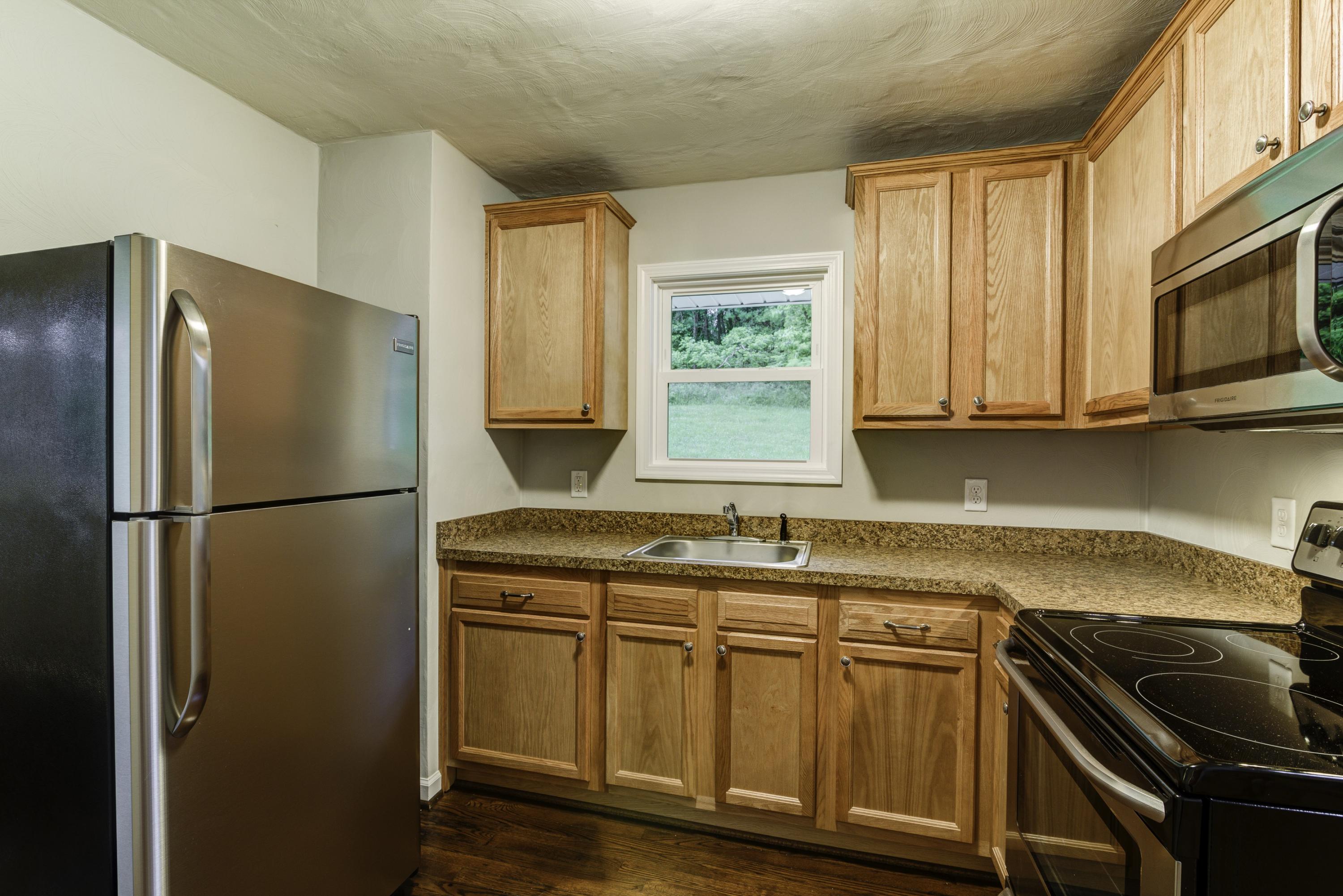 4600 Blue Ridge Boulevard Blue Ridge, VA 24064 - Photo 7 of 27 a kitchen with stainless steel appliances granite countertop a refrigerator sink and stove
