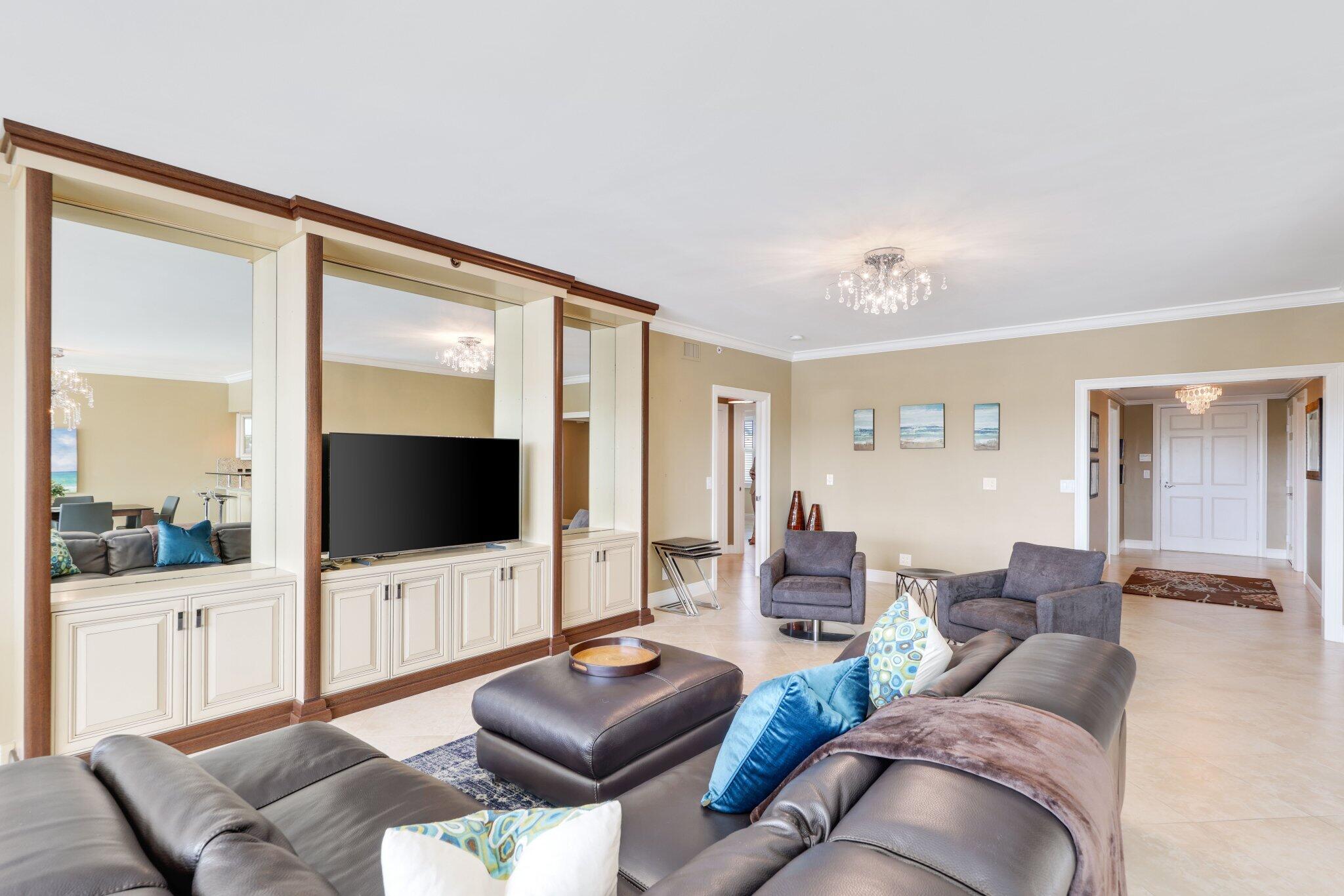 100 Mac Farlane Drive, Unit 3D Delray Beach, FL 33483 - Photo 13 of 57 a living room with furniture and a flat screen tv