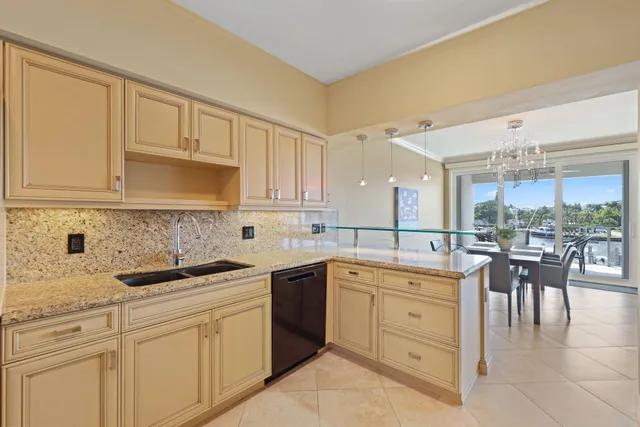 a kitchen with stainless steel appliances granite countertop a stove microwave and sink