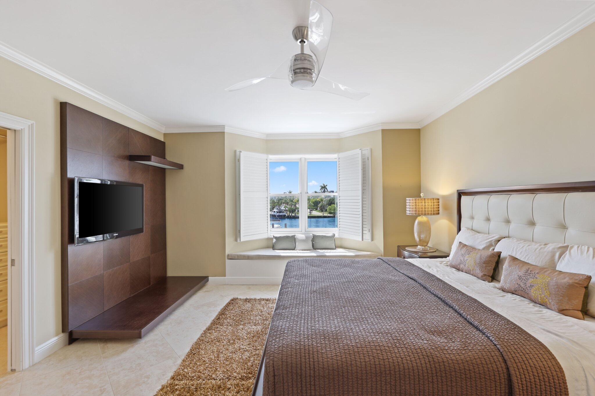 100 Mac Farlane Drive, Unit 3D Delray Beach, FL 33483 - Photo 21 of 57 a bedroom with a large bed and a flat screen tv