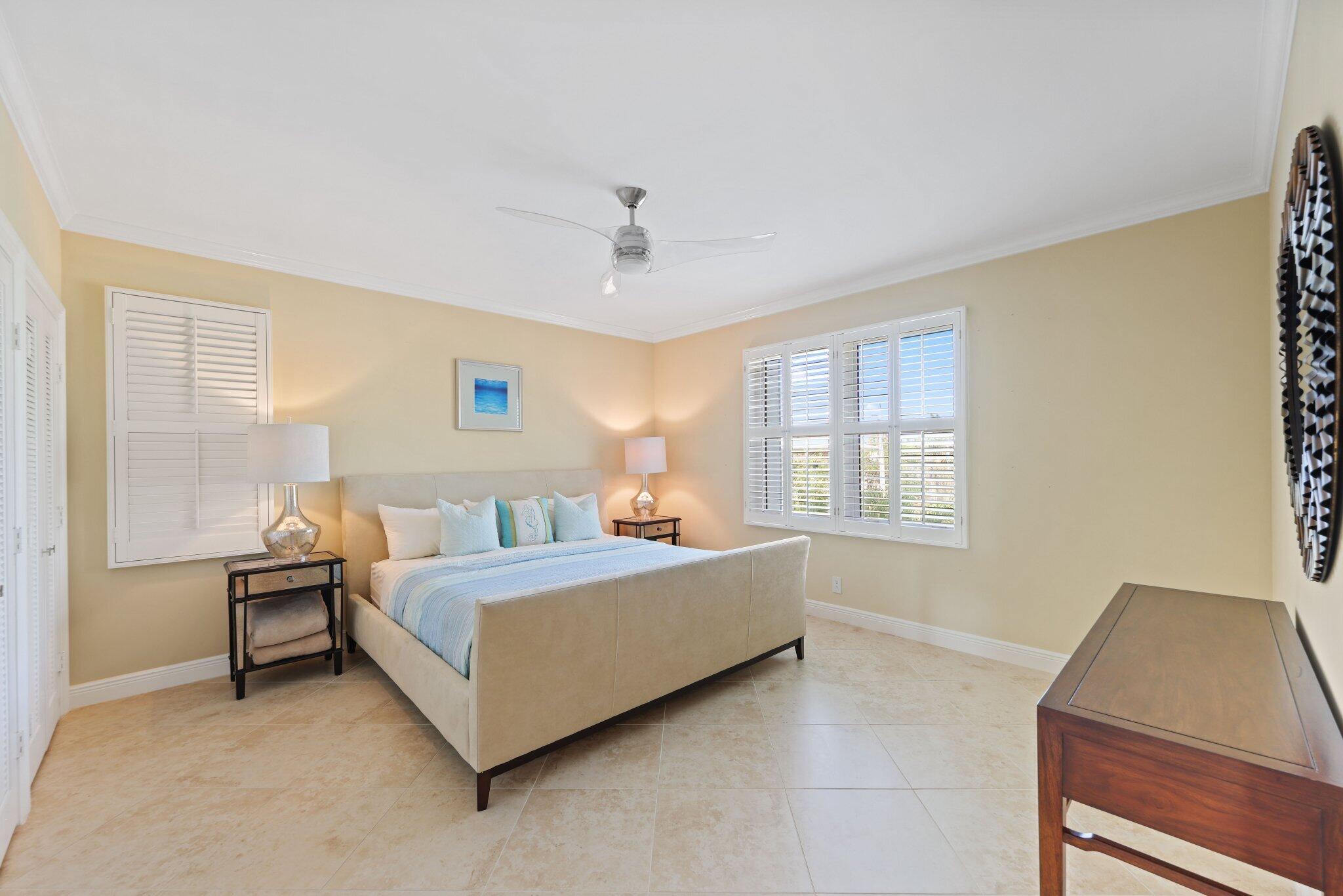 100 Mac Farlane Drive, Unit 3D Delray Beach, FL 33483 - Photo 33 of 57 a room with a bed and a desk