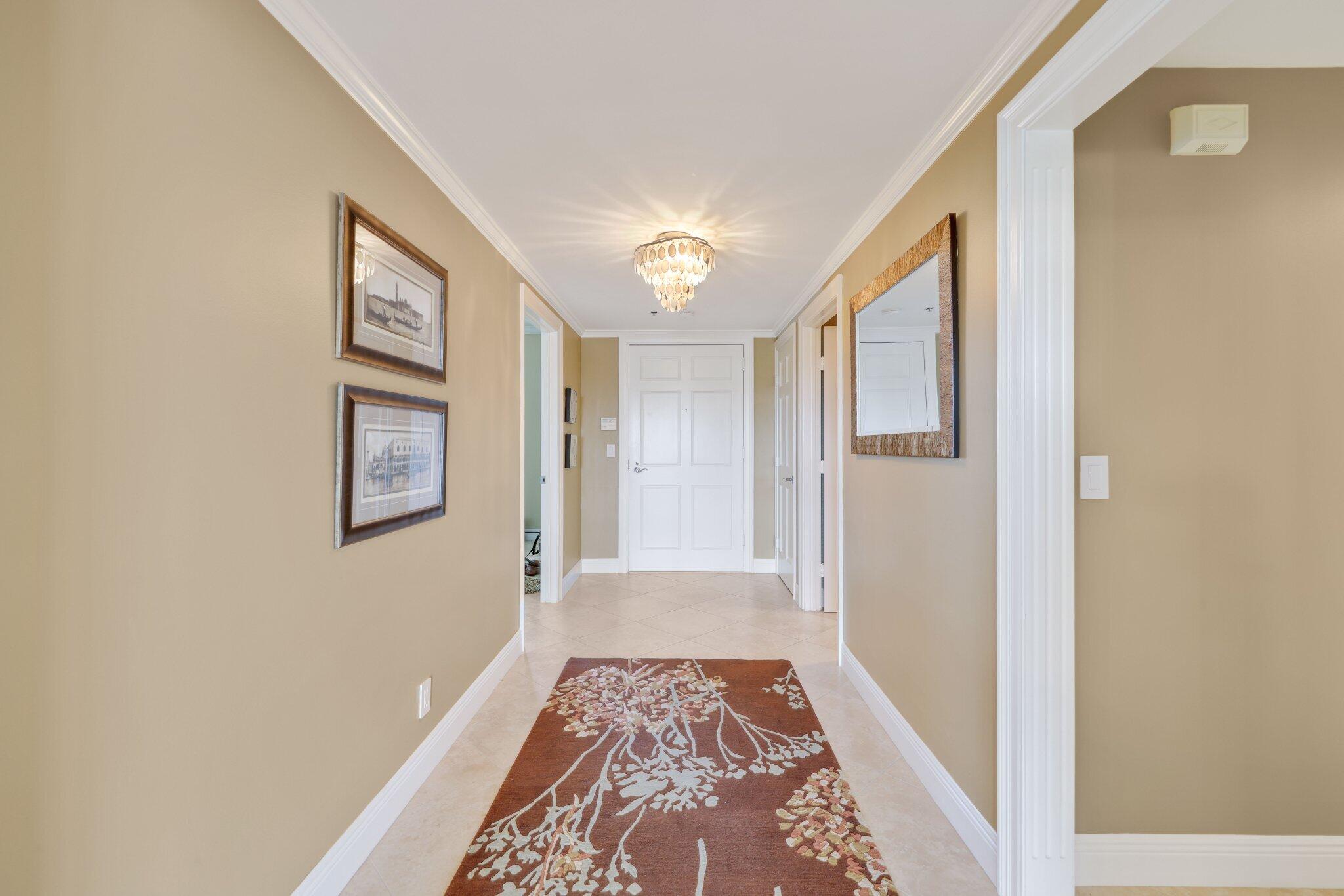 100 Mac Farlane Drive, Unit 3D Delray Beach, FL 33483 - Photo 7 of 57 a view of hallway with a rug and a window
