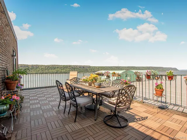 a view of a balcony with furniture and wooden floor