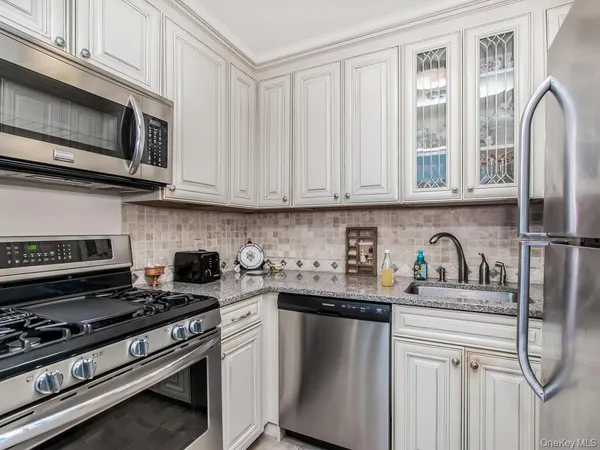 a kitchen with stainless steel appliances granite countertop a stove and a microwave