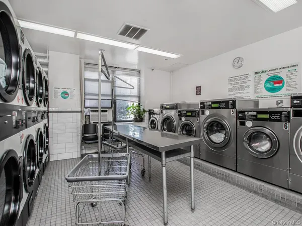 a utility room with multiple dryer and washer