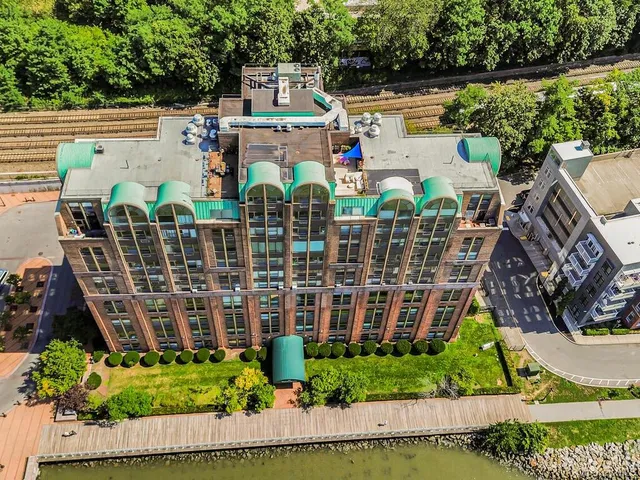 a view of a brick building next to a yard