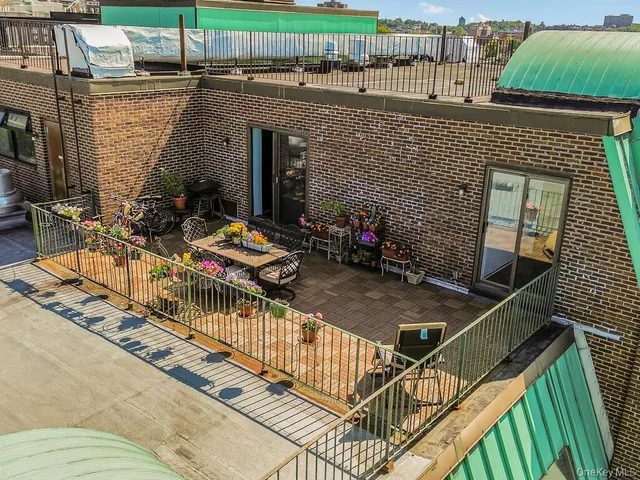 a view of a chairs and table in the back yard