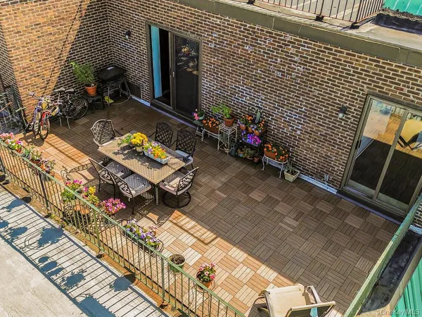 a view of a chairs and table in the back yard