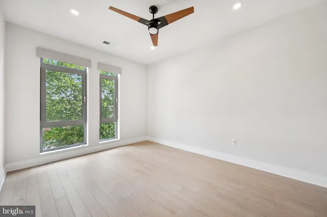 a view of a room with a window and a ceiling fan
