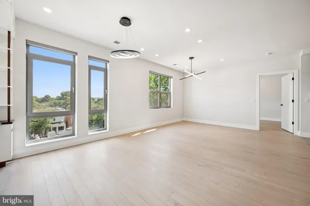 a view of a livingroom with furniture wooden floor and window