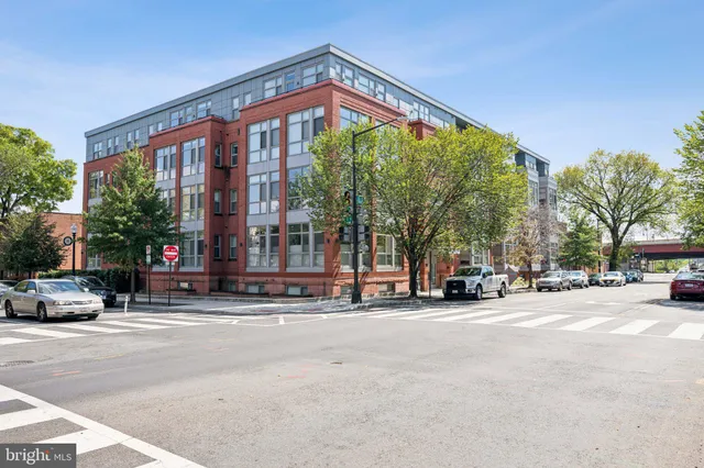a building with a lots of trees in front of it