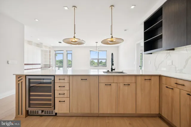 a kitchen with granite countertop a sink stainless steel appliances and cabinets
