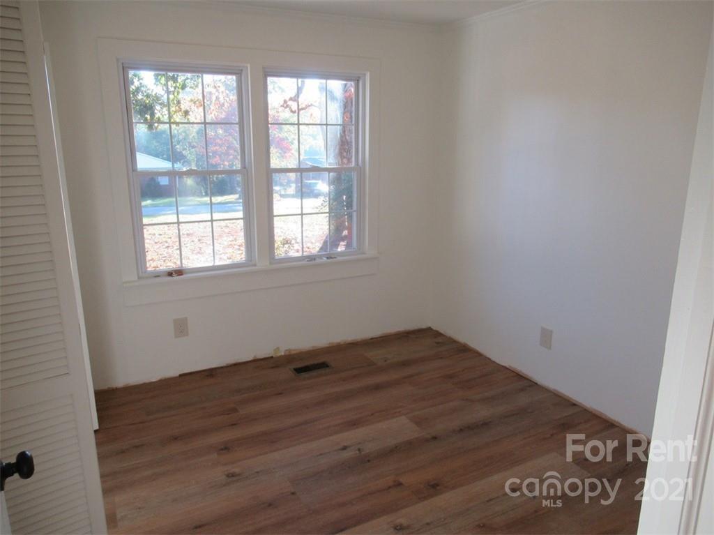 1058 Springdale Drive Maiden, NC 28650 - Photo 14 of 21 an empty room with wooden floor and windows