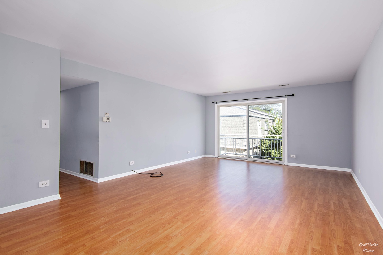 4608 Euclid Avenue, Unit 2B Rolling Meadows, IL 60008 - Photo 3 of 14 a view of an empty room with wooden floor and a window