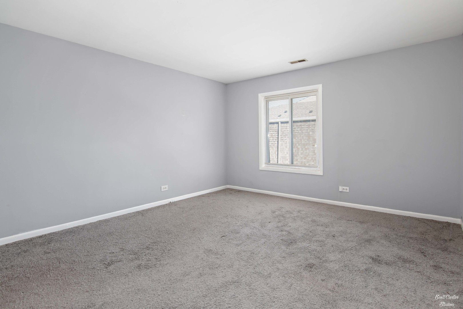 4608 Euclid Avenue, Unit 2B Rolling Meadows, IL 60008 - Photo 9 of 14 an empty room with windows