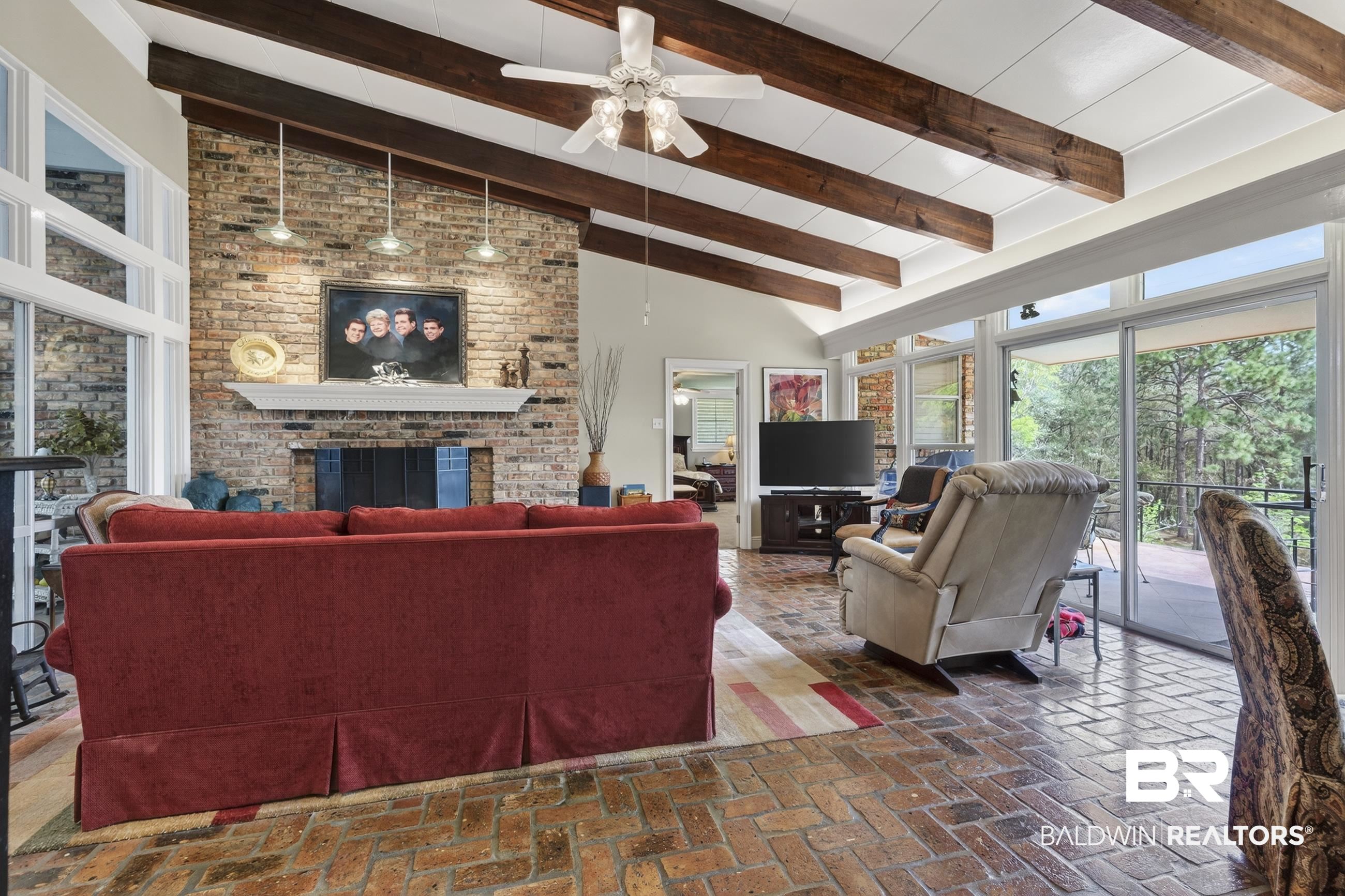 3175 Dawes Lake Road Mobile, AL 36619 - Photo 4 of 92 Living area featuring brick flooring, ceiling fan, a fireplace, and lofted ceiling
