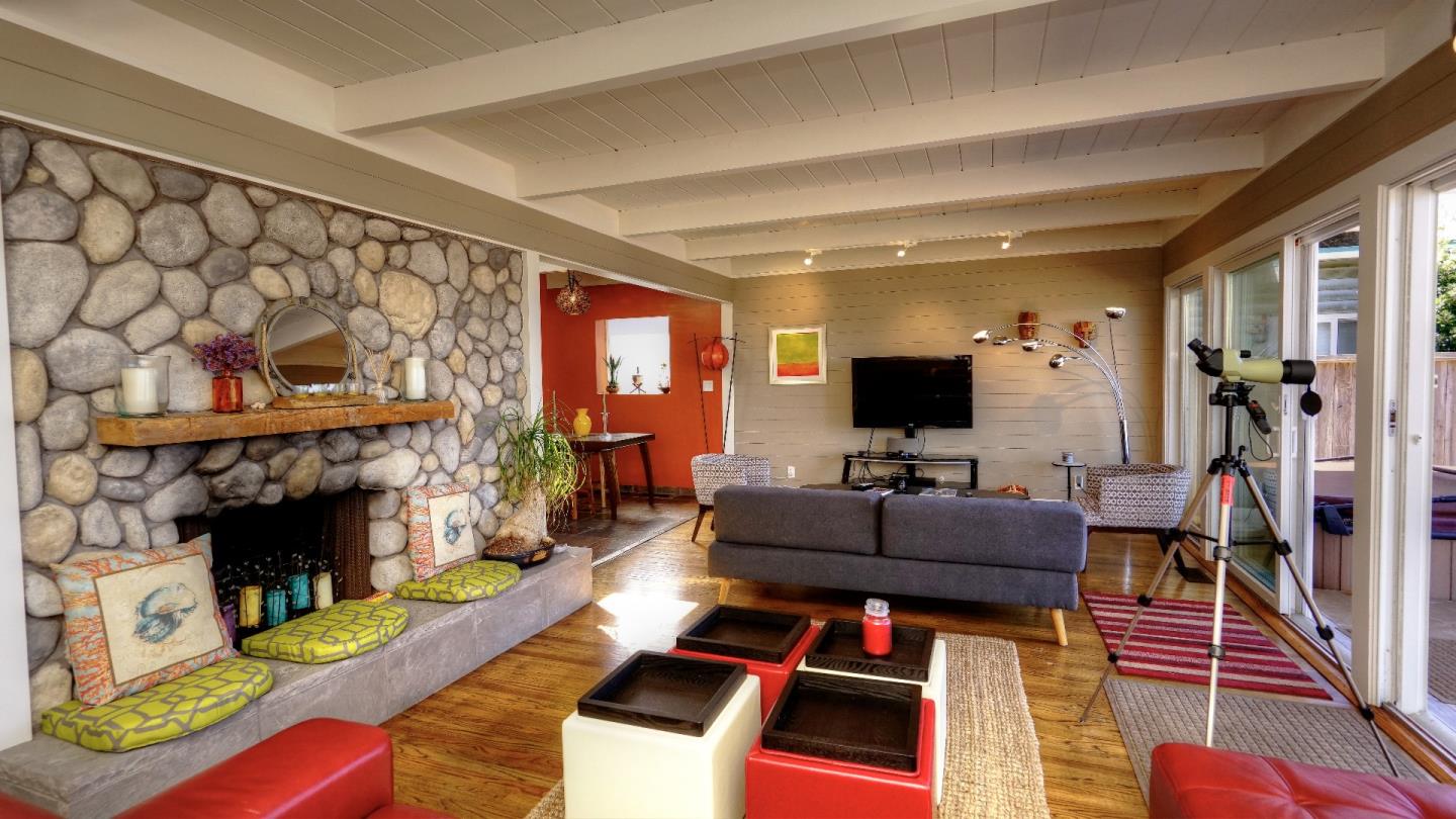 97 Beach Street Moss Beach, CA 94038 - Photo 14 of 43 a living room with furniture a flat screen tv and a fireplace