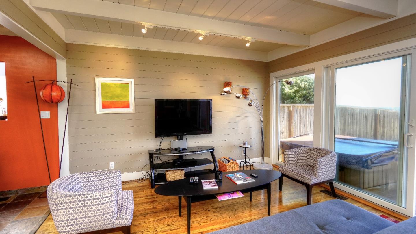 97 Beach Street Moss Beach, CA 94038 - Photo 15 of 43 a living room with furniture and a flat screen tv
