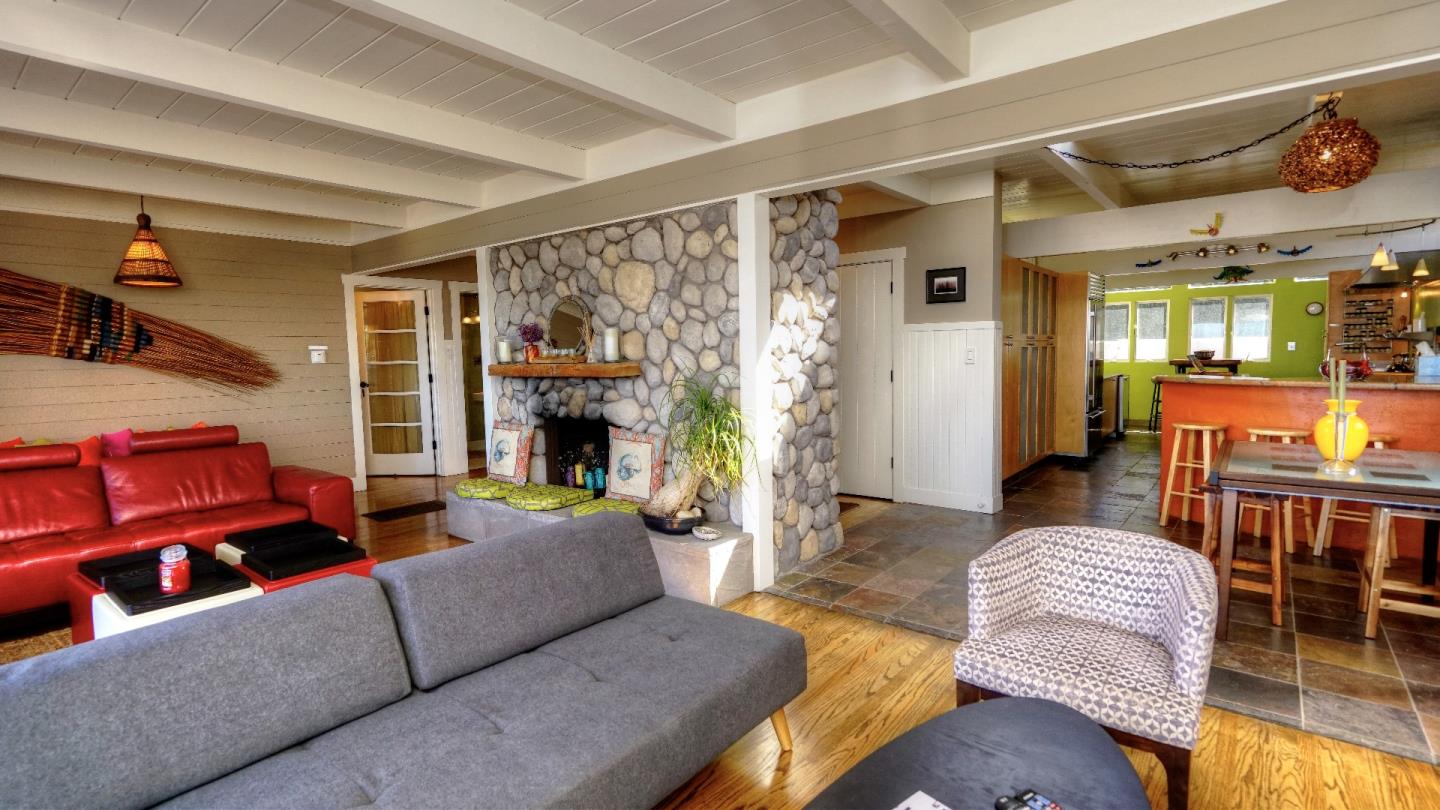 97 Beach Street Moss Beach, CA 94038 - Photo 16 of 43 a living room with furniture and a fireplace