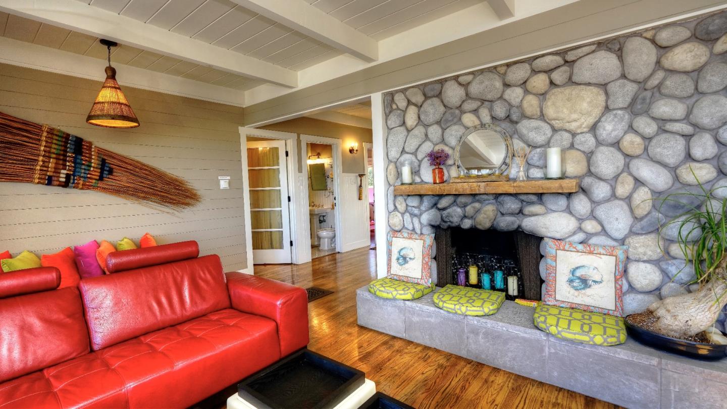 97 Beach Street Moss Beach, CA 94038 - Photo 24 of 43 a living room with furniture and a fireplace