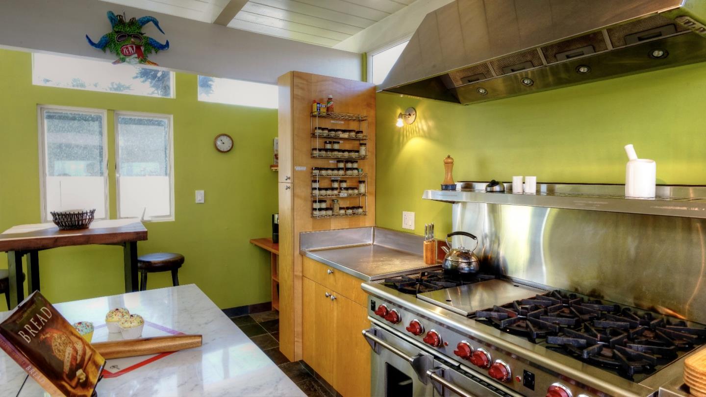 97 Beach Street Moss Beach, CA 94038 - Photo 30 of 43 a kitchen with a stove and a wooden floor