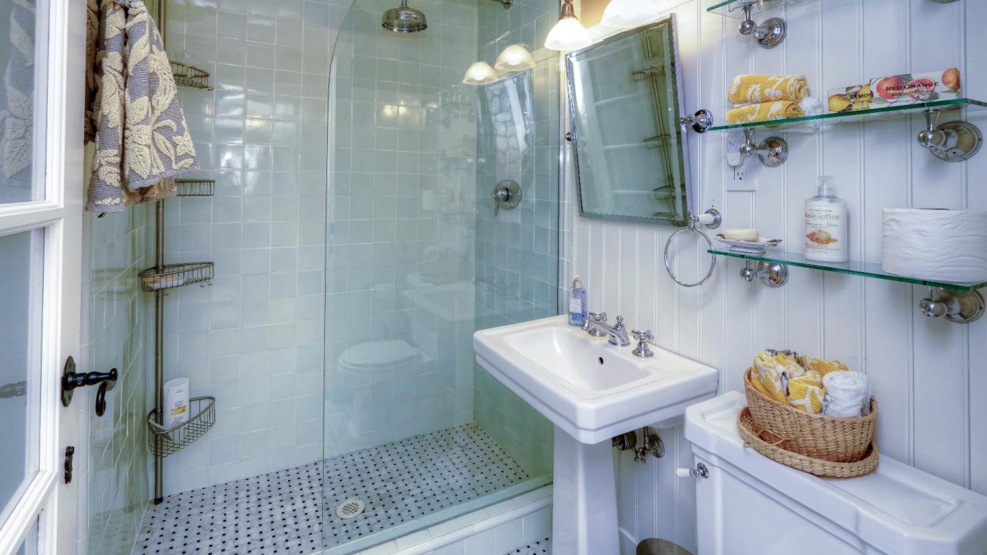 97 Beach Street Moss Beach, CA 94038 - Photo 40 of 43 a bathroom with a sink a toilet and shower