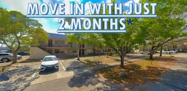 en empty room with wooden floor ceiling fan and window