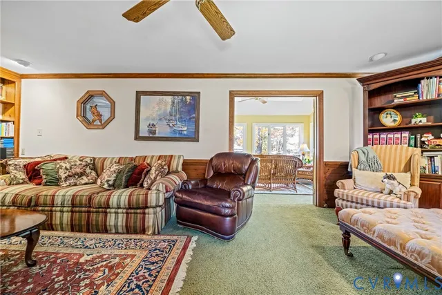 a living room with furniture and a bookshelf