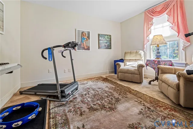 a living room with furniture a rug and a window