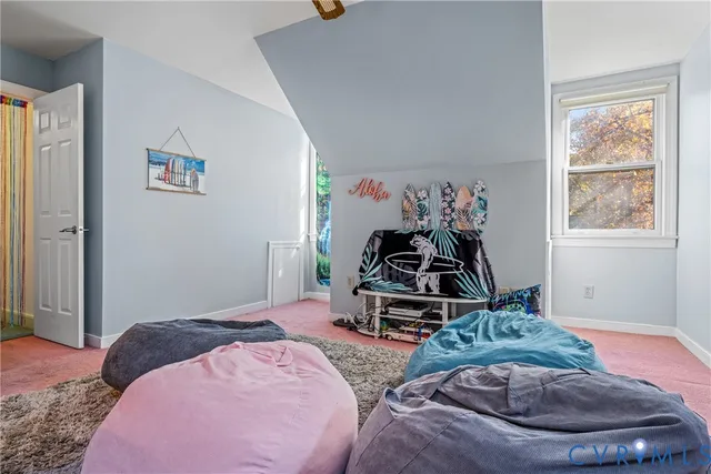 a bedroom with a bed and a wooden floor