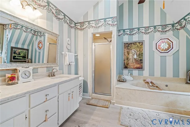 a spacious bathroom with a sink a mirror a bathtub and shower