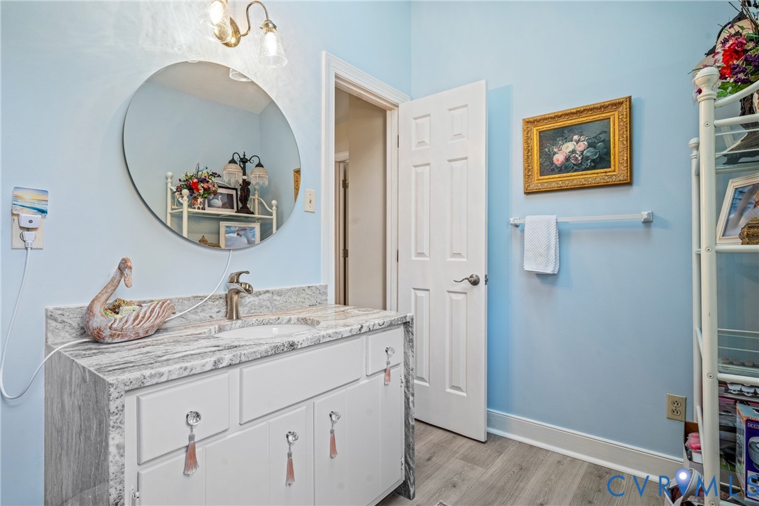 8404 Copperpenny Terrace Chesterfield, VA 23832 - Photo 30 of 40 a bathroom with a granite countertop sink a mirror and vanity