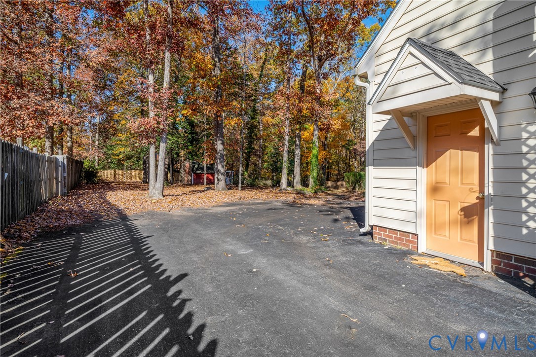 8404 Copperpenny Terrace Chesterfield, VA 23832 - Photo 32 of 40 a view of backyard with wooden fence and trees