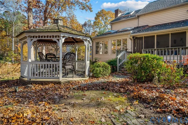 a view of a yard with large trees and a barn