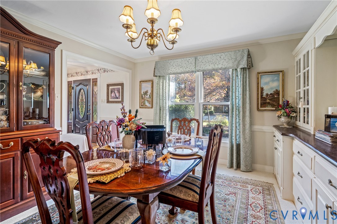 8404 Copperpenny Terrace Chesterfield, VA 23832 - Photo 7 of 40 a view of a dining room with furniture a livingroom and chandelier