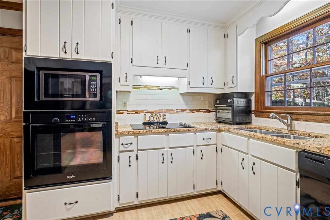 8404 Copperpenny Terrace Chesterfield, VA 23832 - Photo 8 of 40 a kitchen with granite countertop white cabinets and window