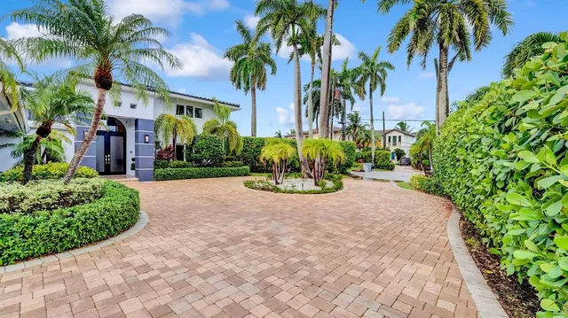 a kitchen with stainless steel appliances granite countertop a stove a sink dishwasher and a refrigerator with wooden floor